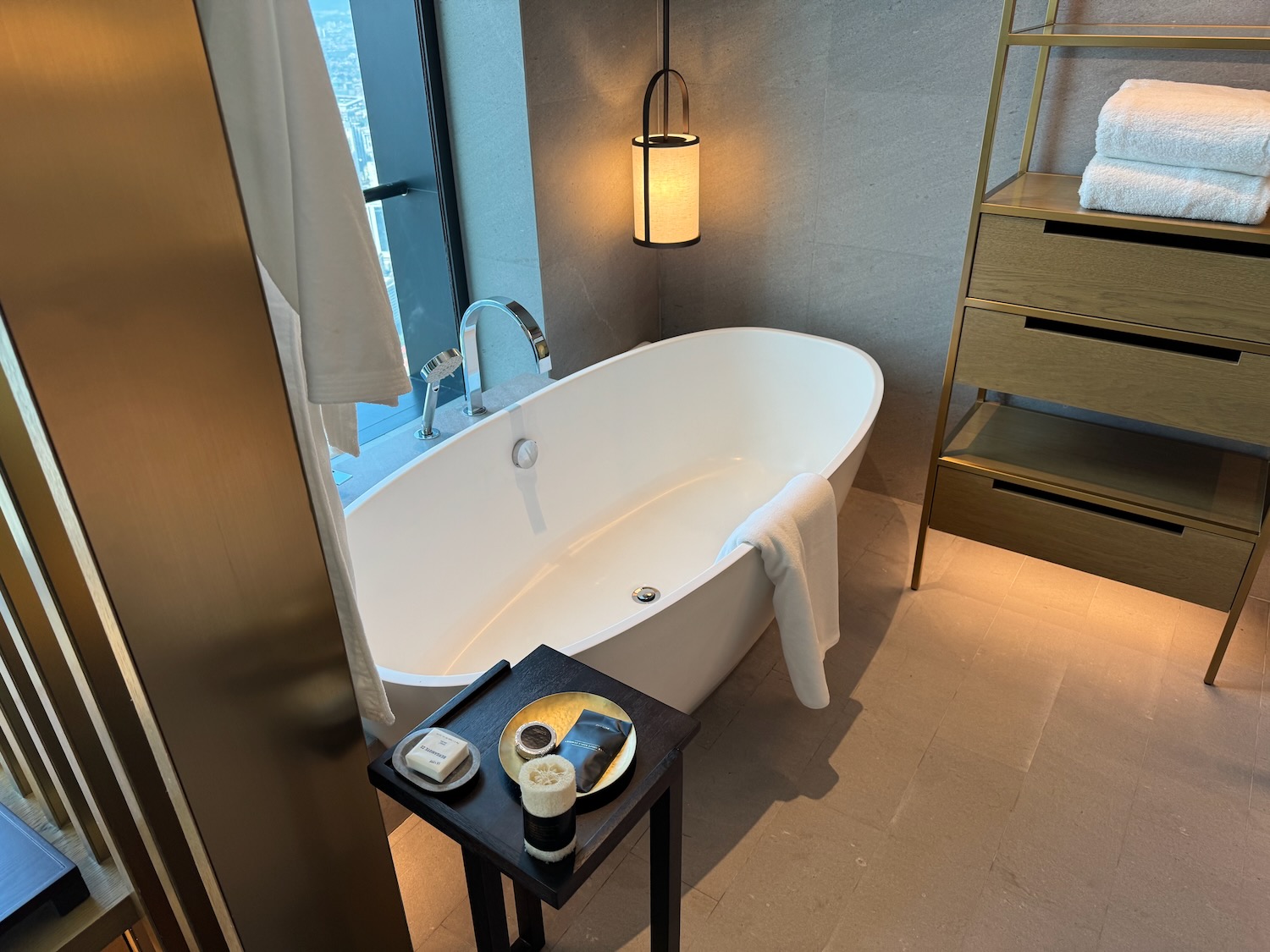 a bathroom with a bathtub and a small table