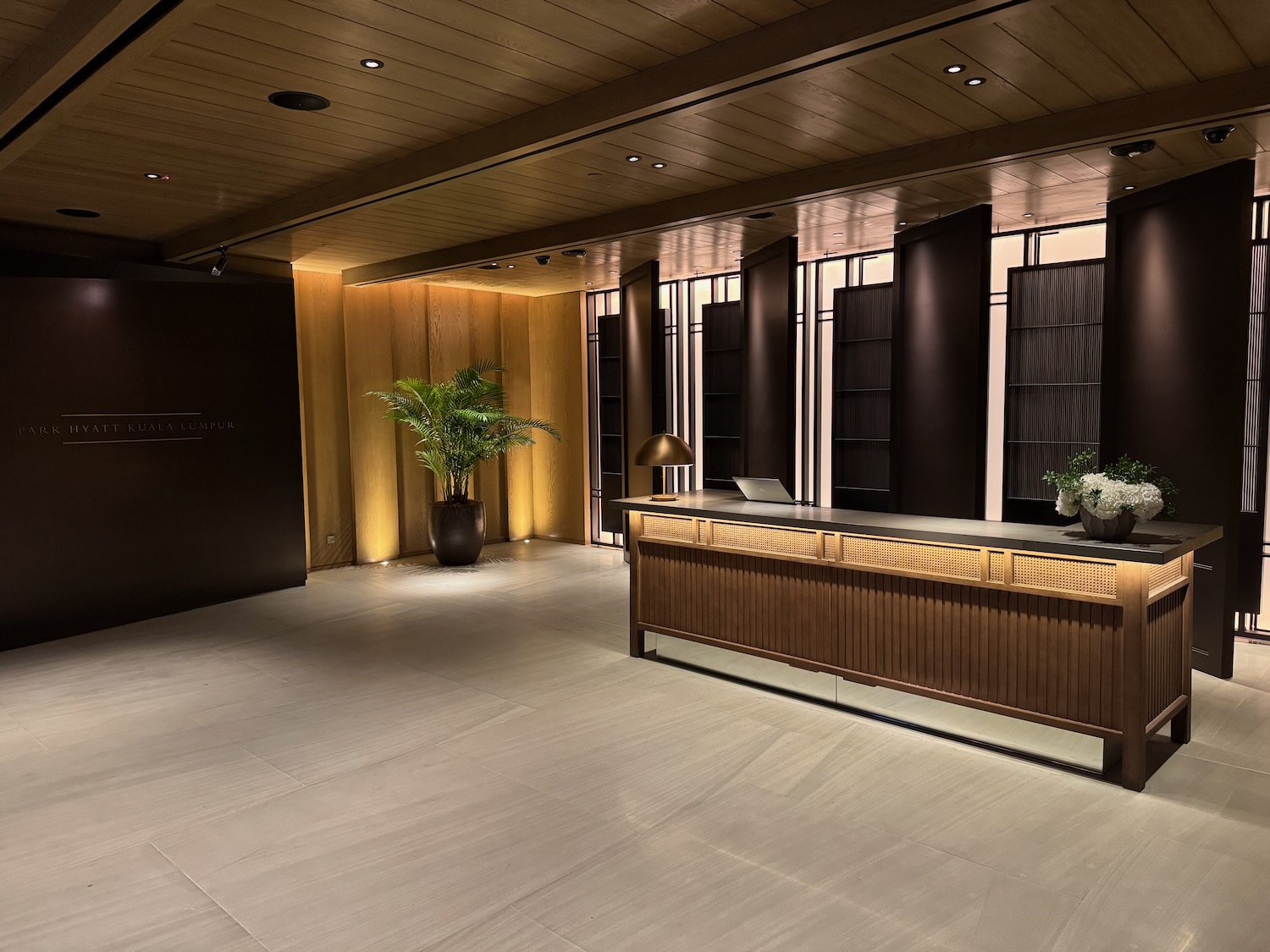 a lobby with a reception desk and plants