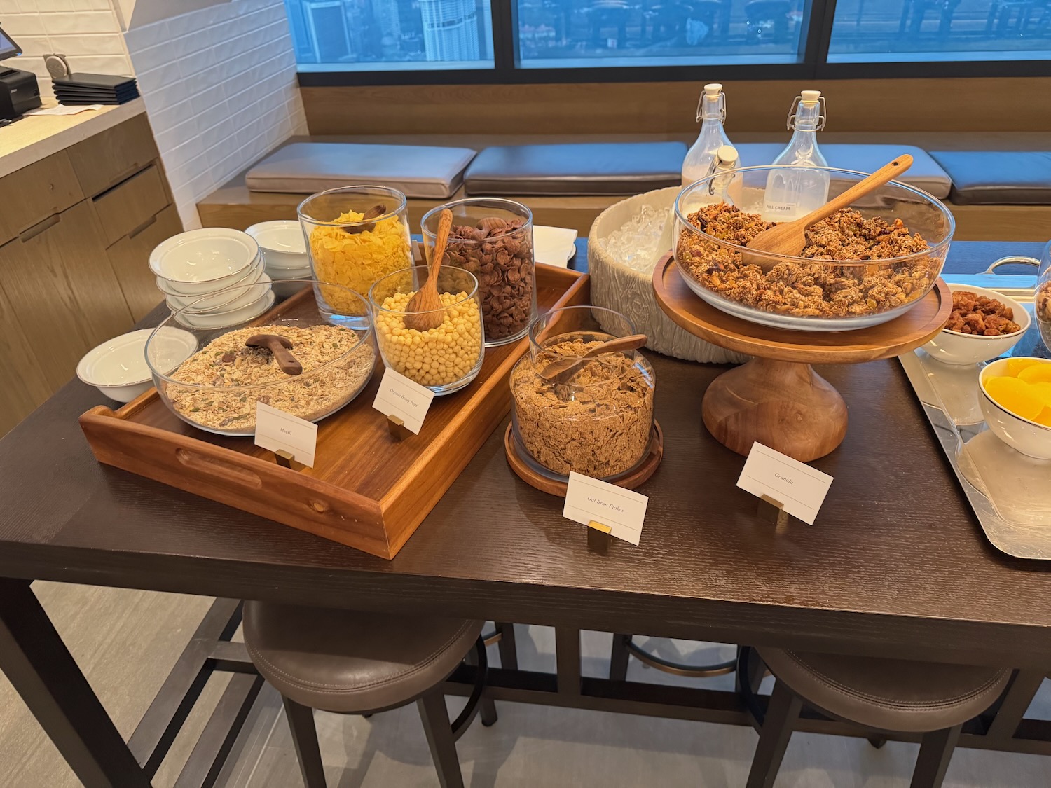 a table with bowls of cereals and bowls of food