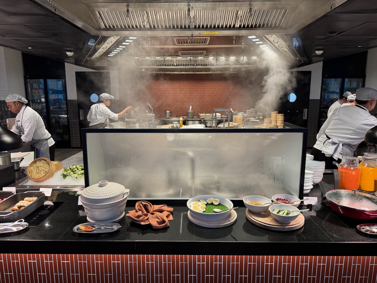 a group of chefs cooking in a kitchen
