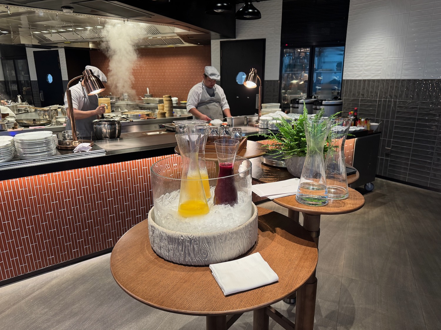a kitchen with a chef cooking in the background