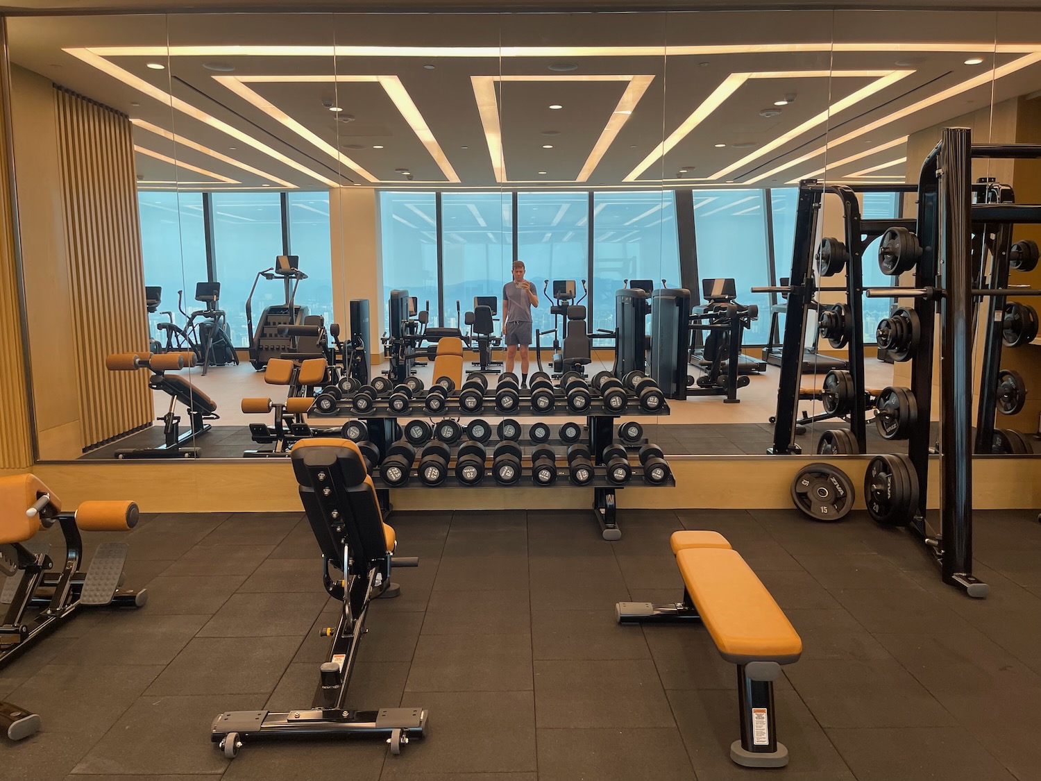 a large room with a large mirror and a large mirror with weights