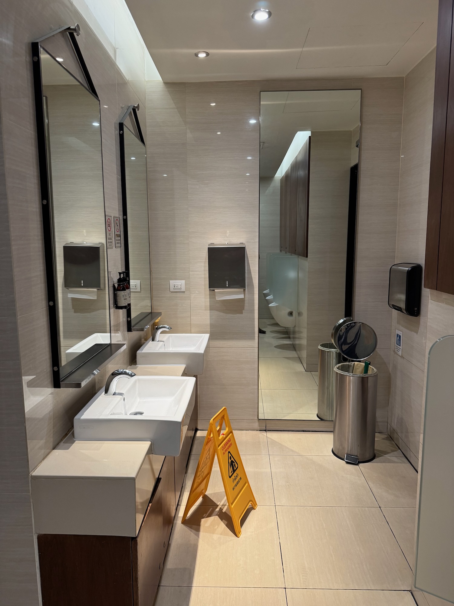 a bathroom with a yellow sign