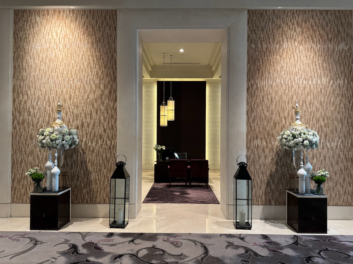 a hallway with flowers and lanterns