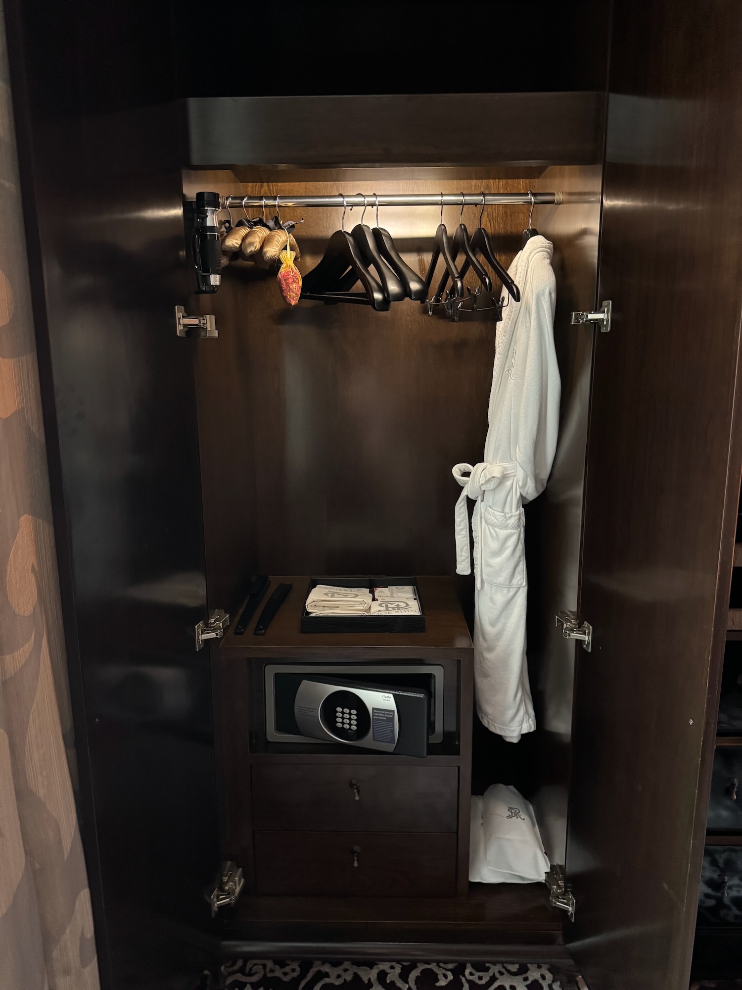 a closet with a white robe and swingers