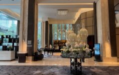 a large room with chandeliers and a table