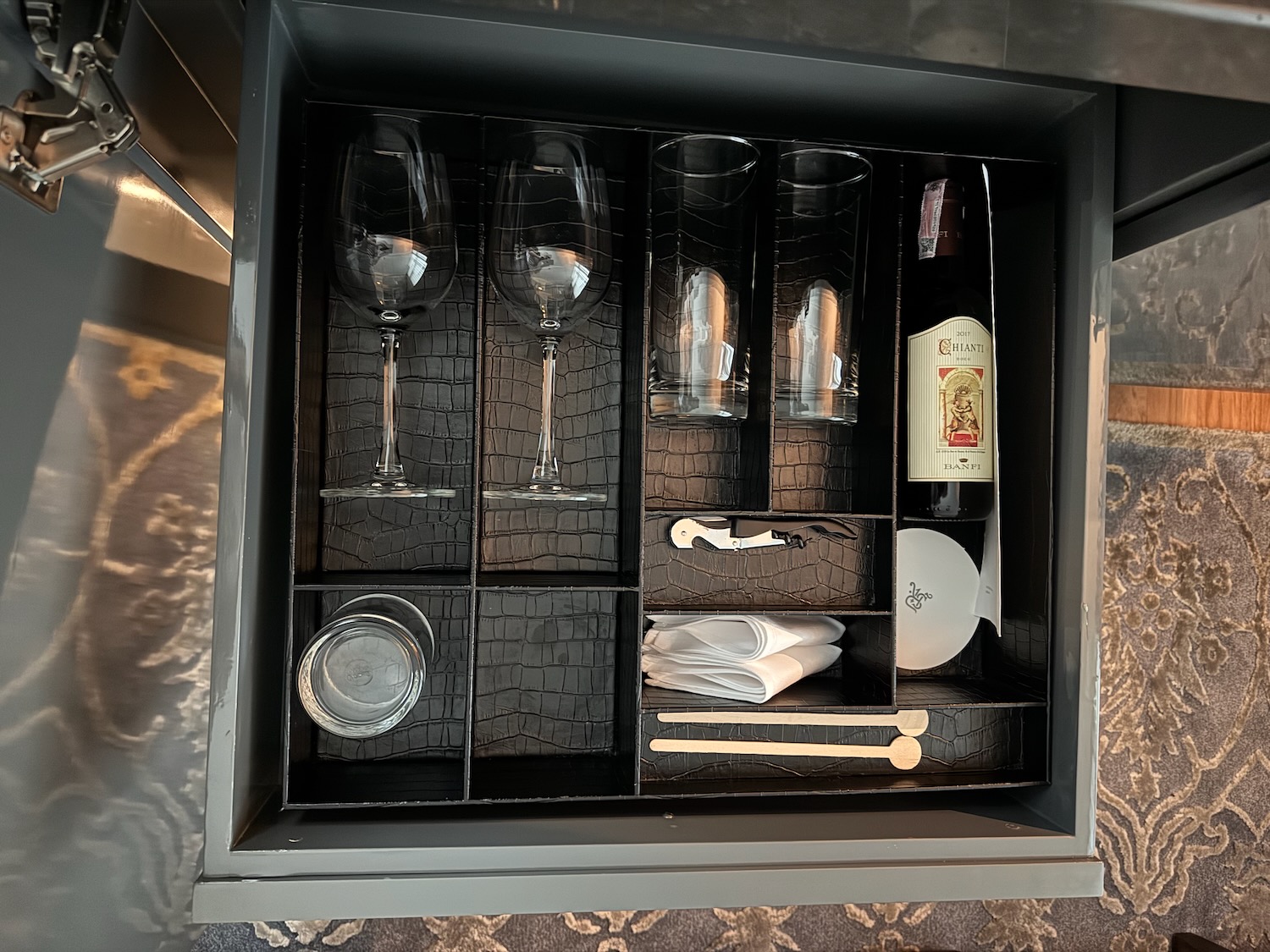 a wine glasses and a bottle in a drawer