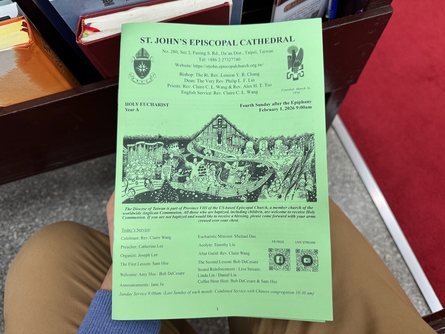 a person holding a green paper