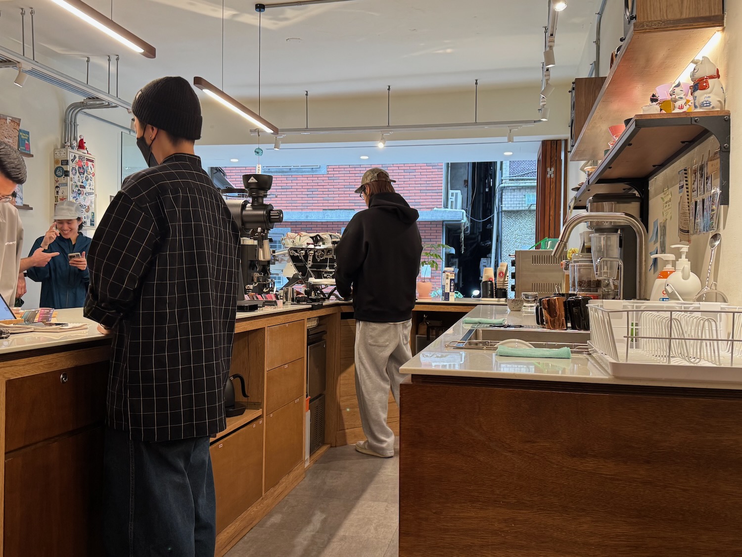 a group of people standing in a coffee shop