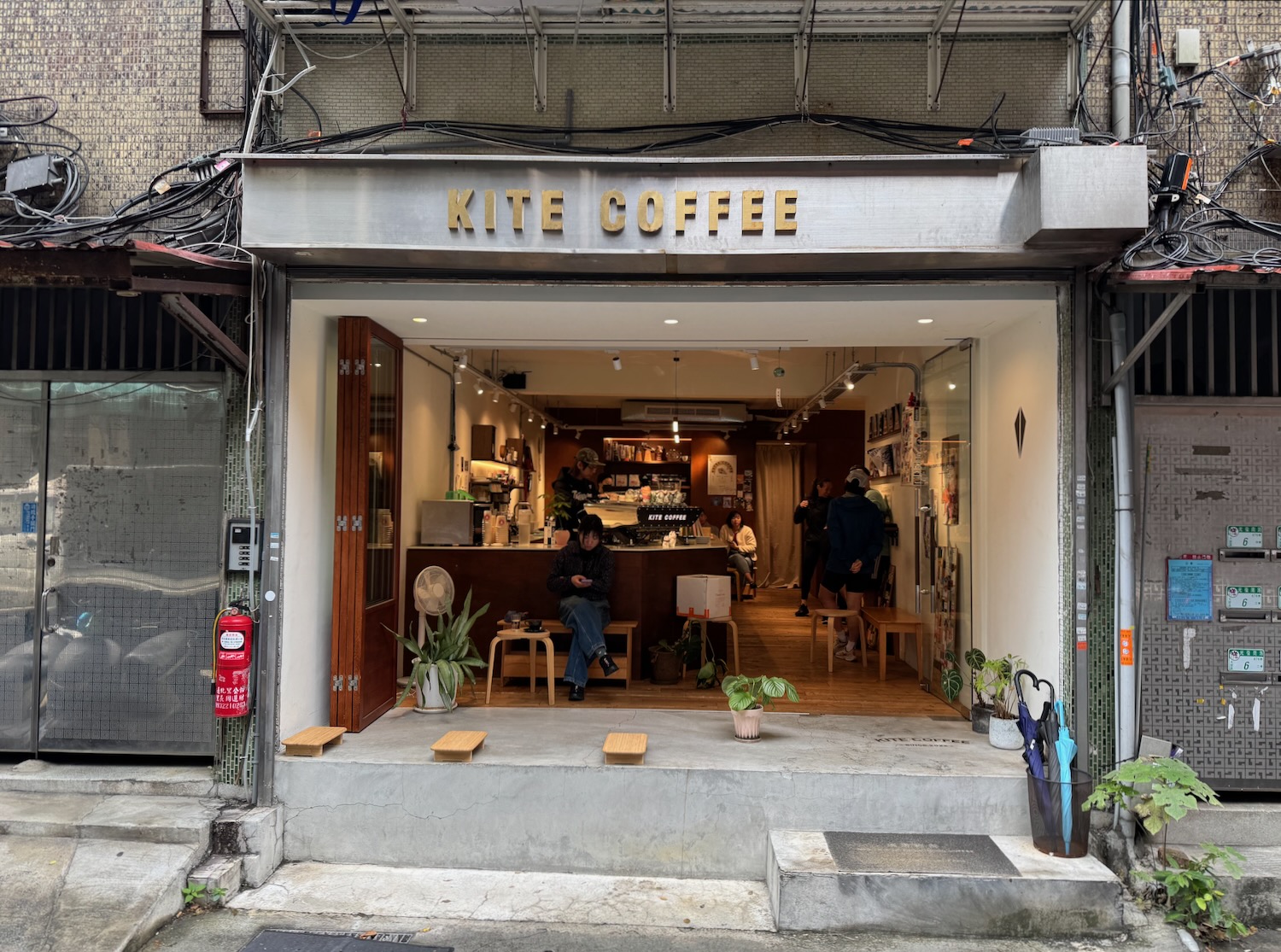 a coffee shop with a man sitting at a counter