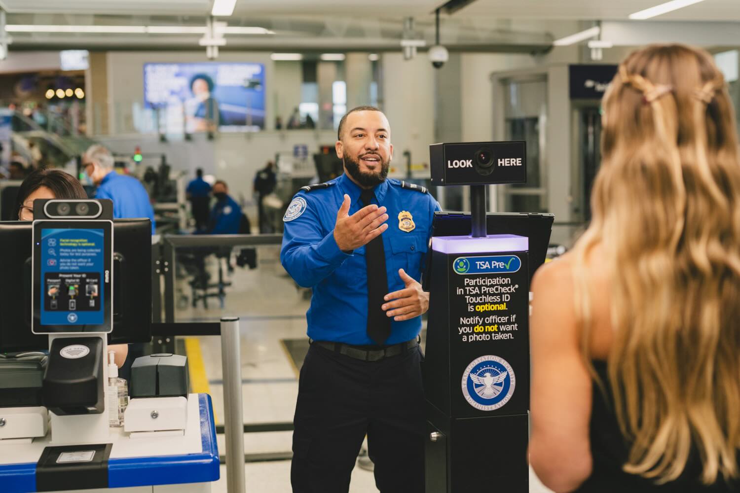 a man in a blue shirt talking to a woman
