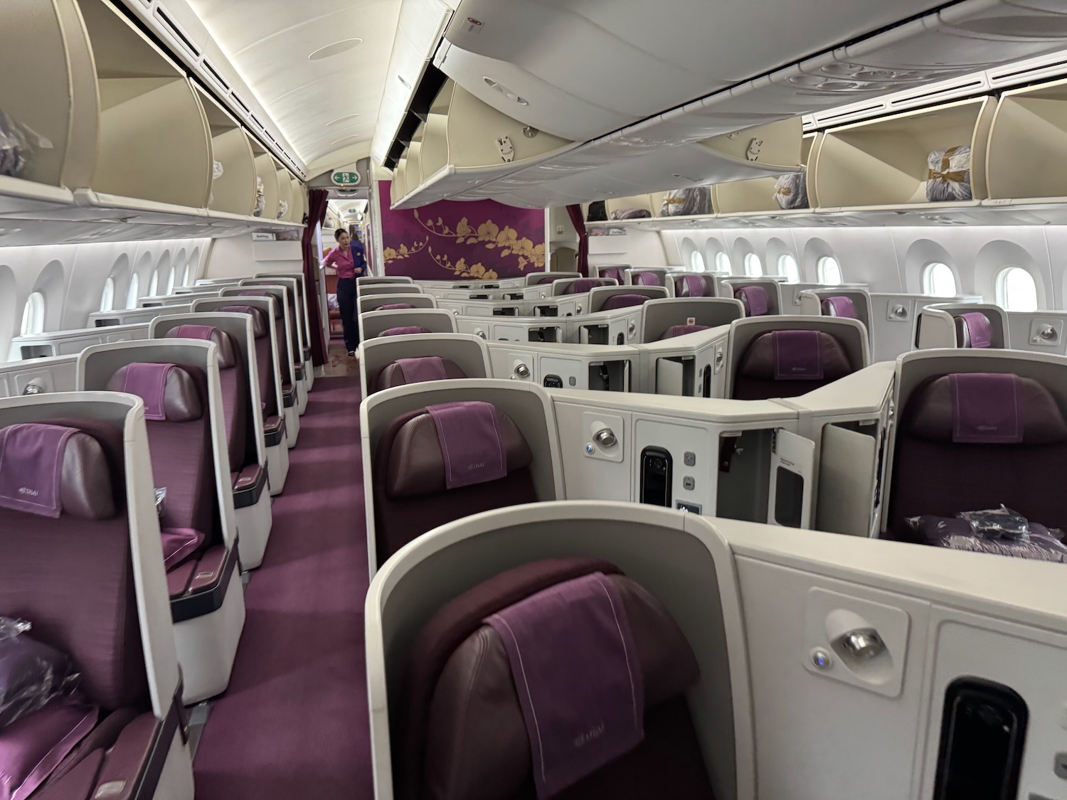 a inside of a plane with purple seats