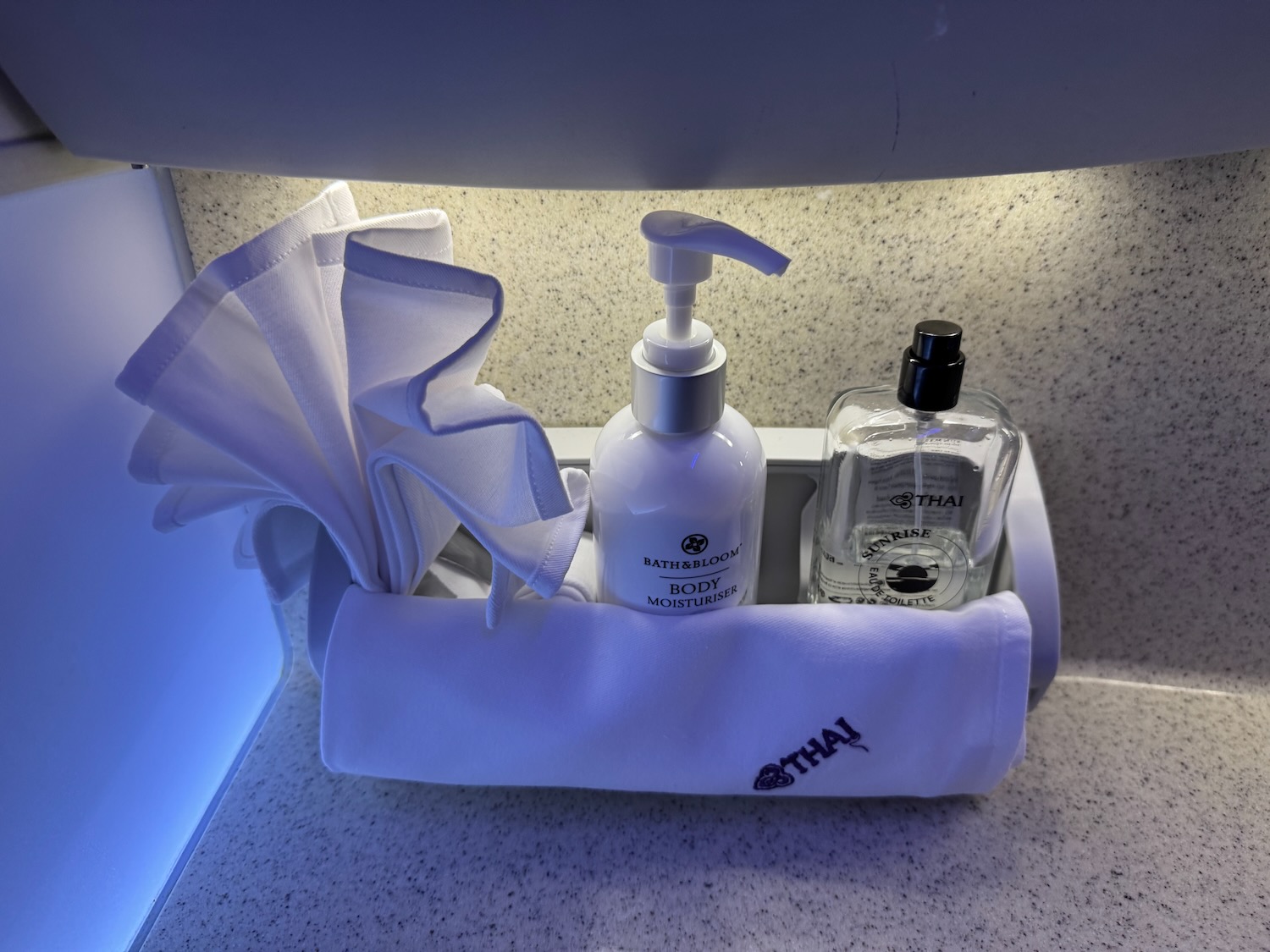 a group of bottles and a towel in a holder