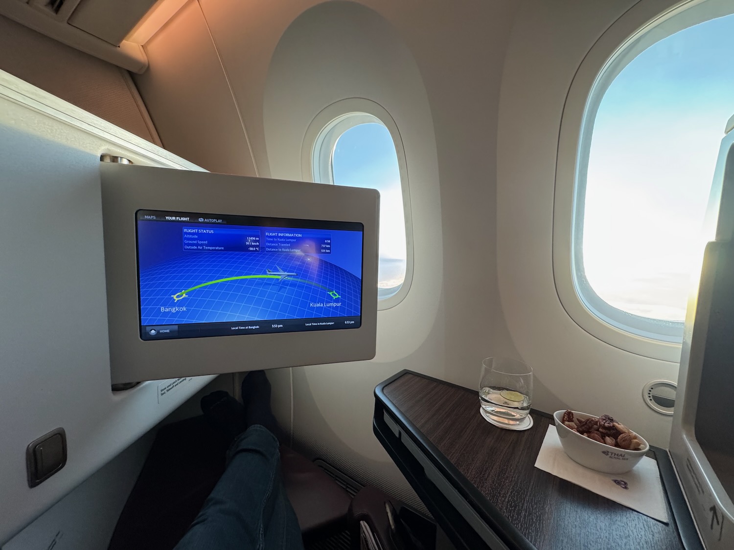 a screen on a table in an airplane