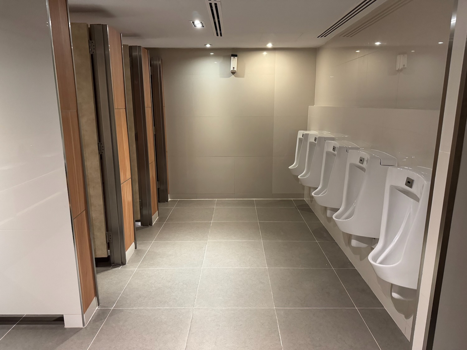 a row of urinals in a public bathroom