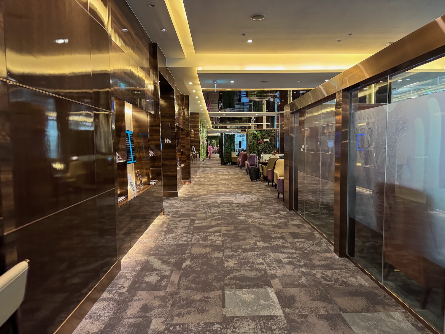 a hallway with glass walls and a large window