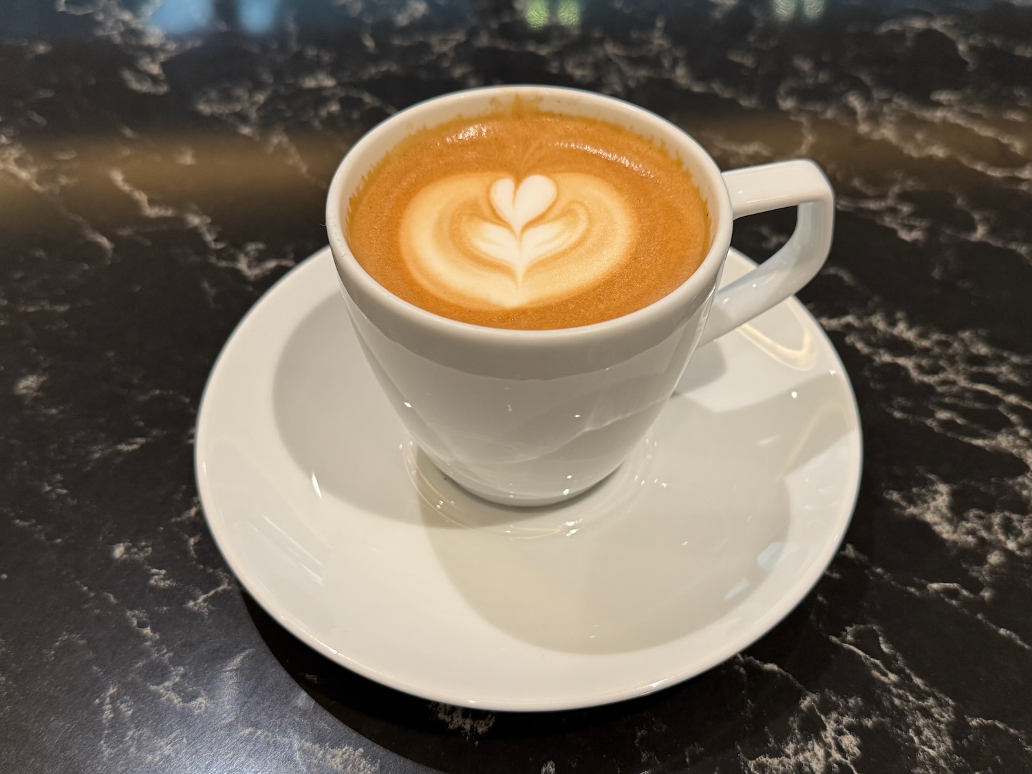 a cup of coffee with a heart in the foam