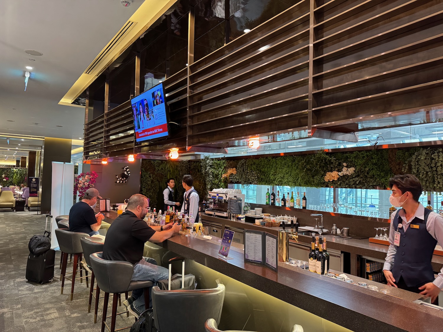 a group of people sitting at a bar