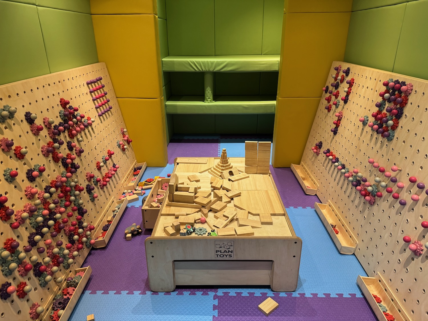 a wooden board game with balls on the wall