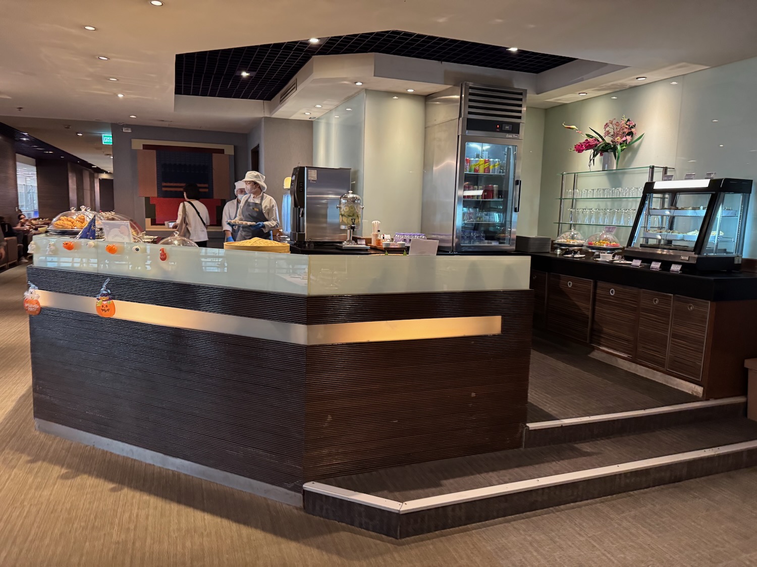 a restaurant with people behind the counter