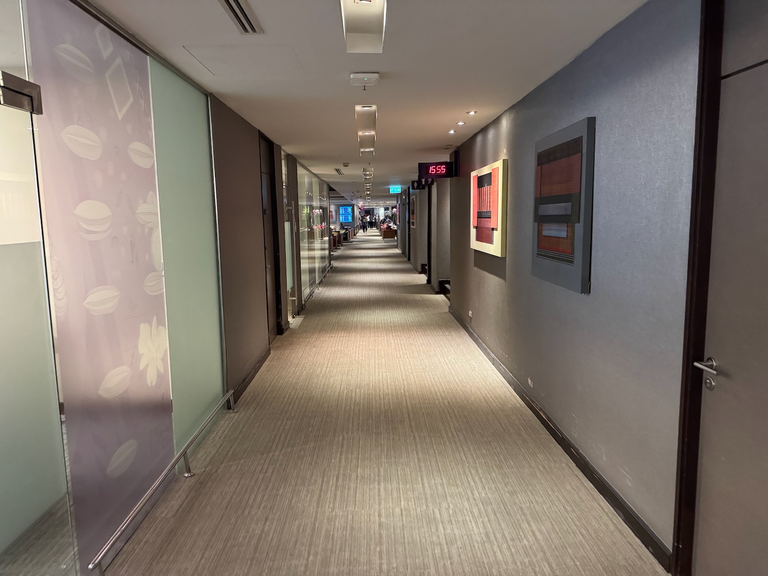 a hallway with many windows and a sign on the wall