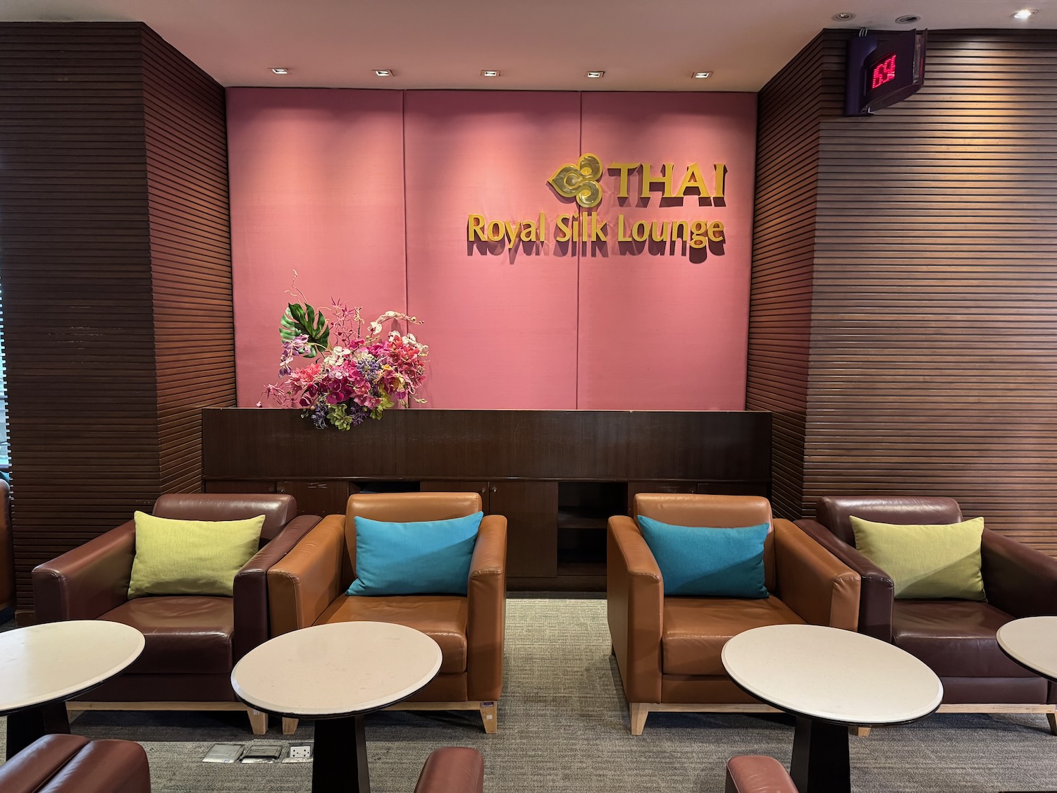 a lounge area with chairs and tables