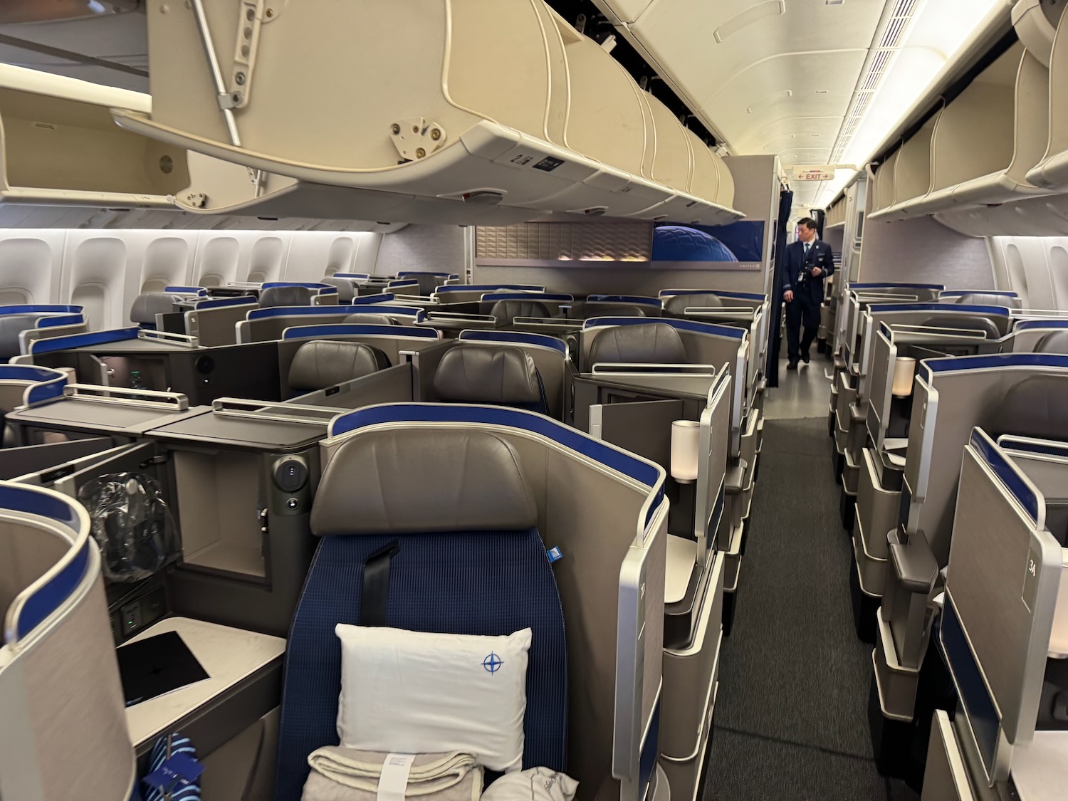 an airplane with seats and a man standing in the back