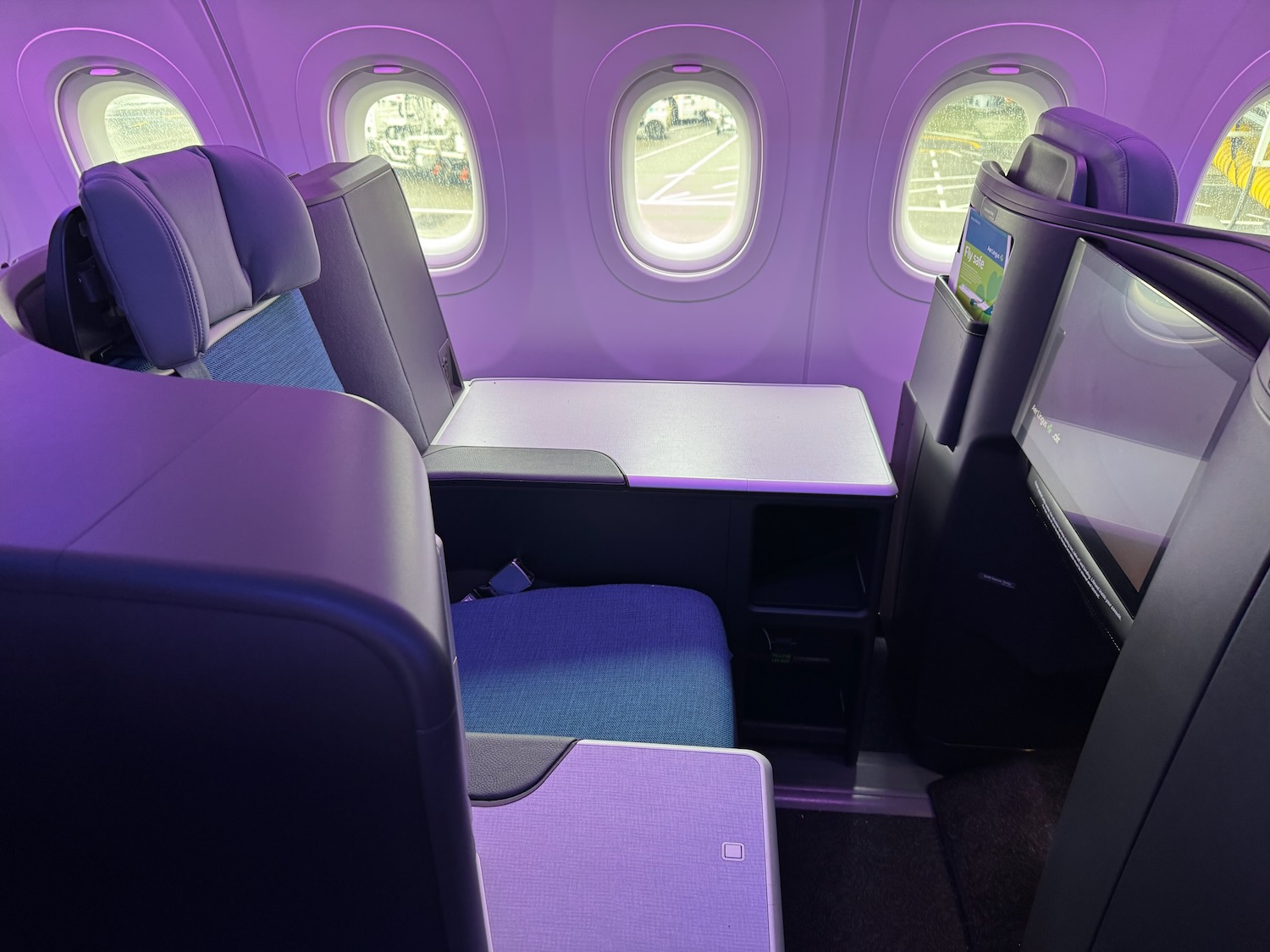 a seat and a television in an airplane