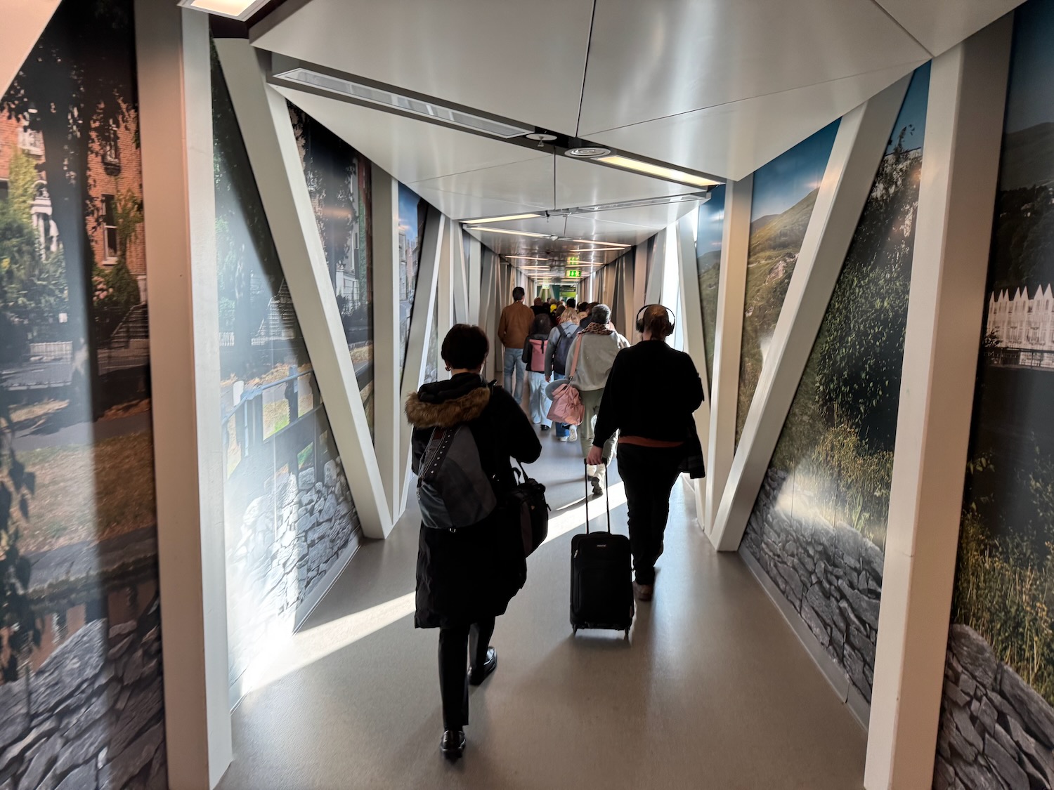 people walking in a tunnel with a group of people