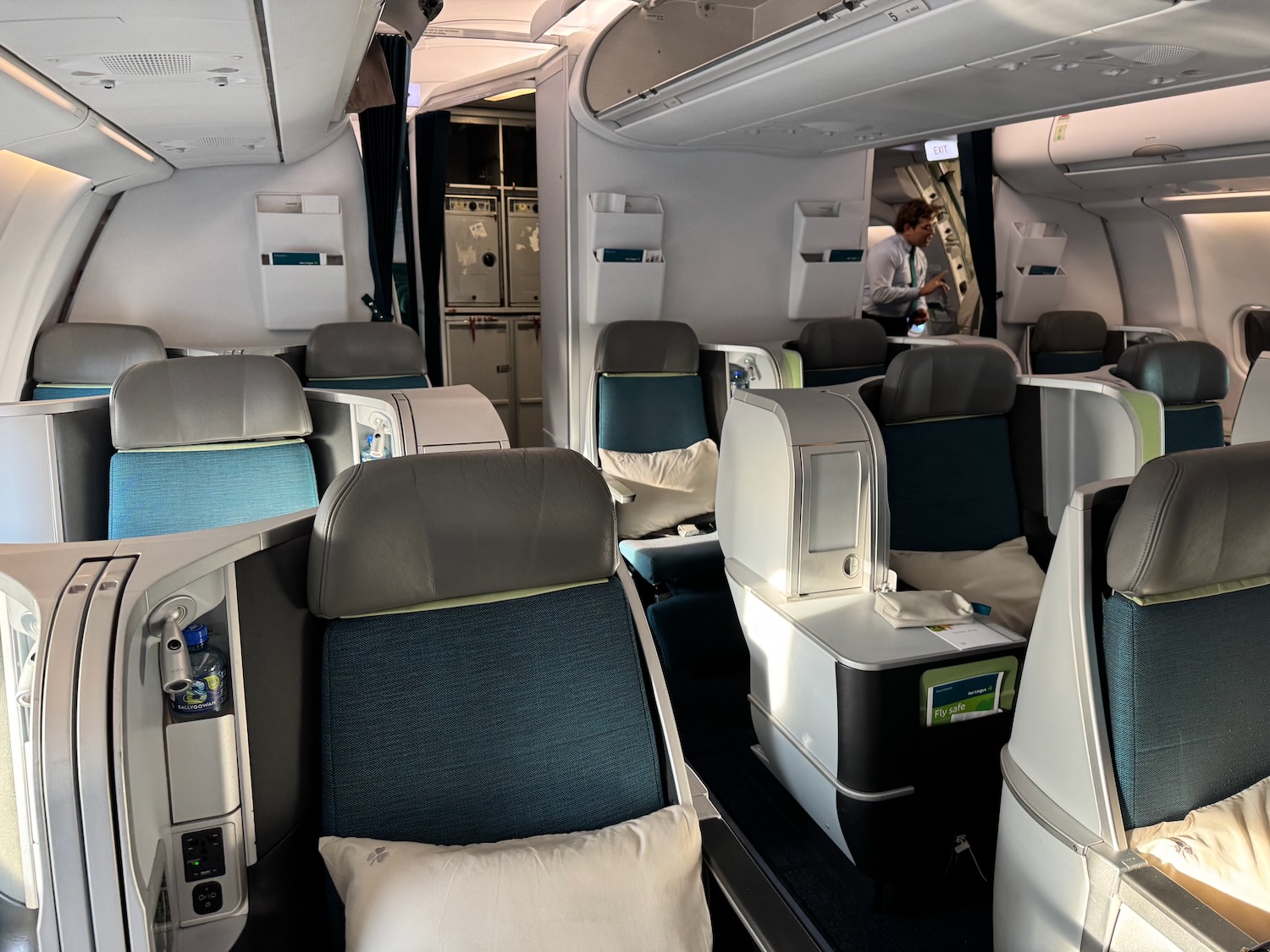 a plane with seats and a man standing in the background