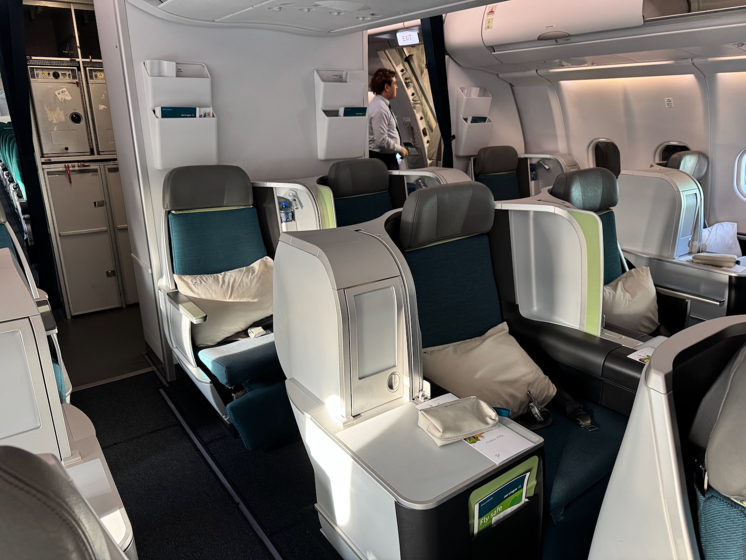 a person standing in a room with chairs and a person standing in the back