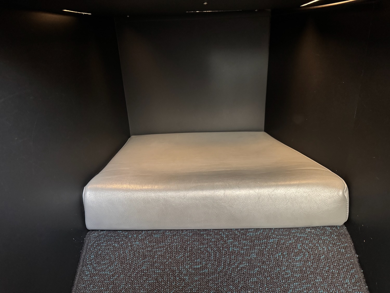 a white cushion in a black box