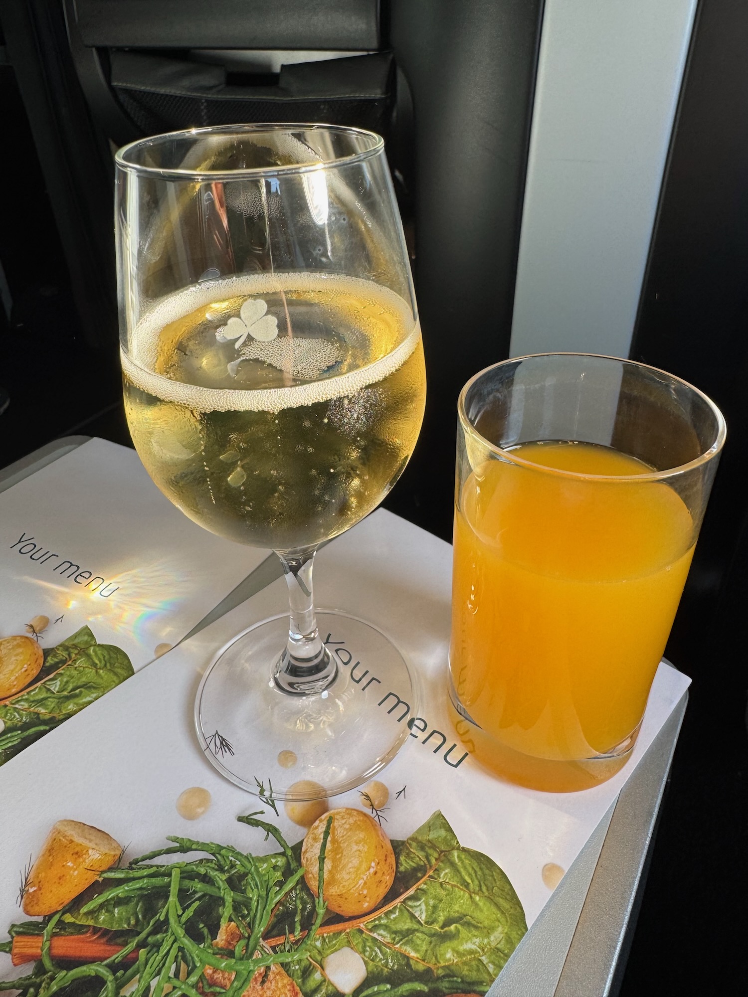 a glass of wine next to a glass of orange juice