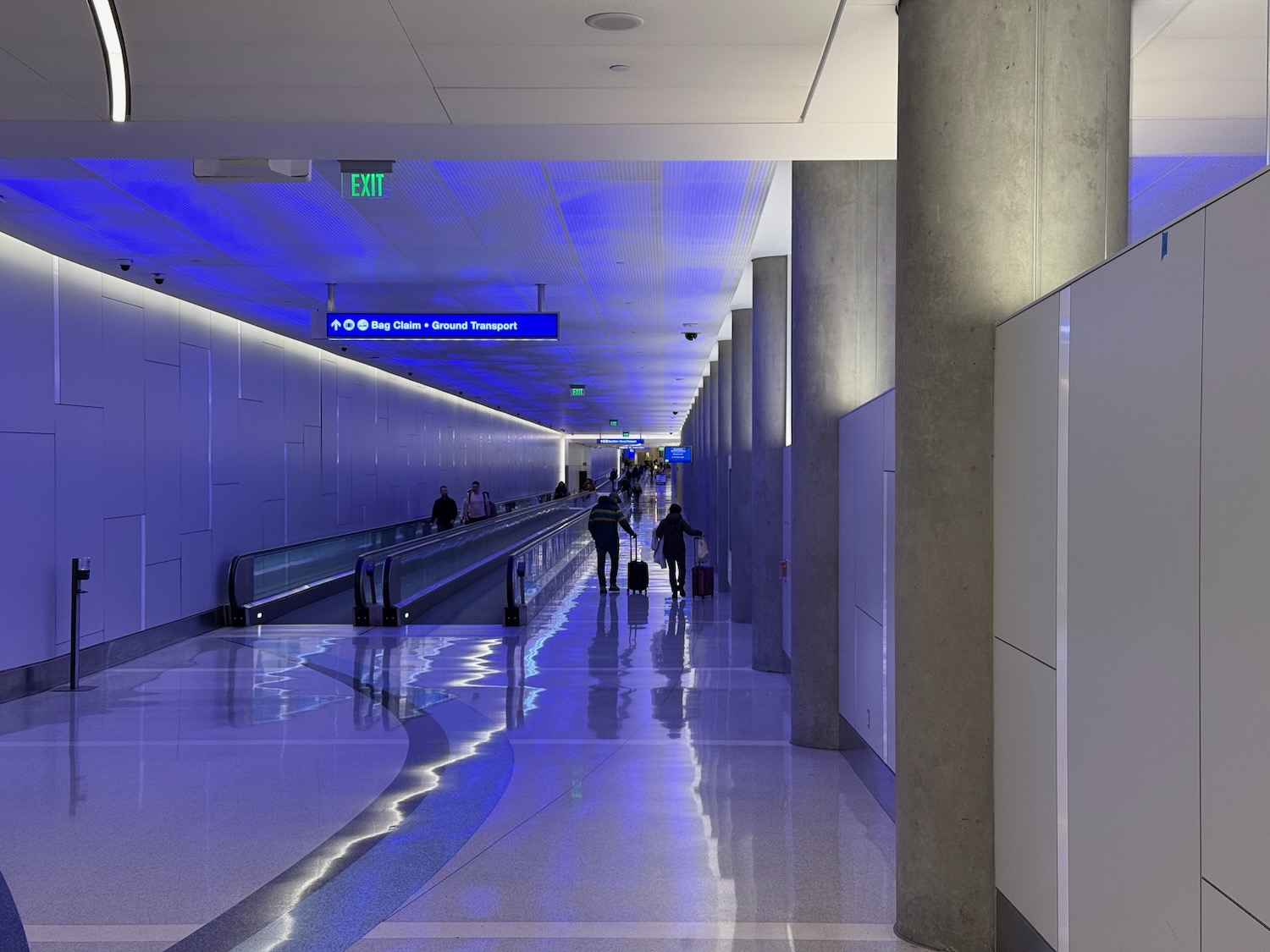 people walking in a hallway