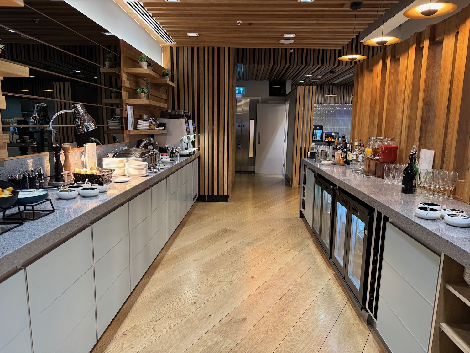 a kitchen with white cabinets and wooden floors