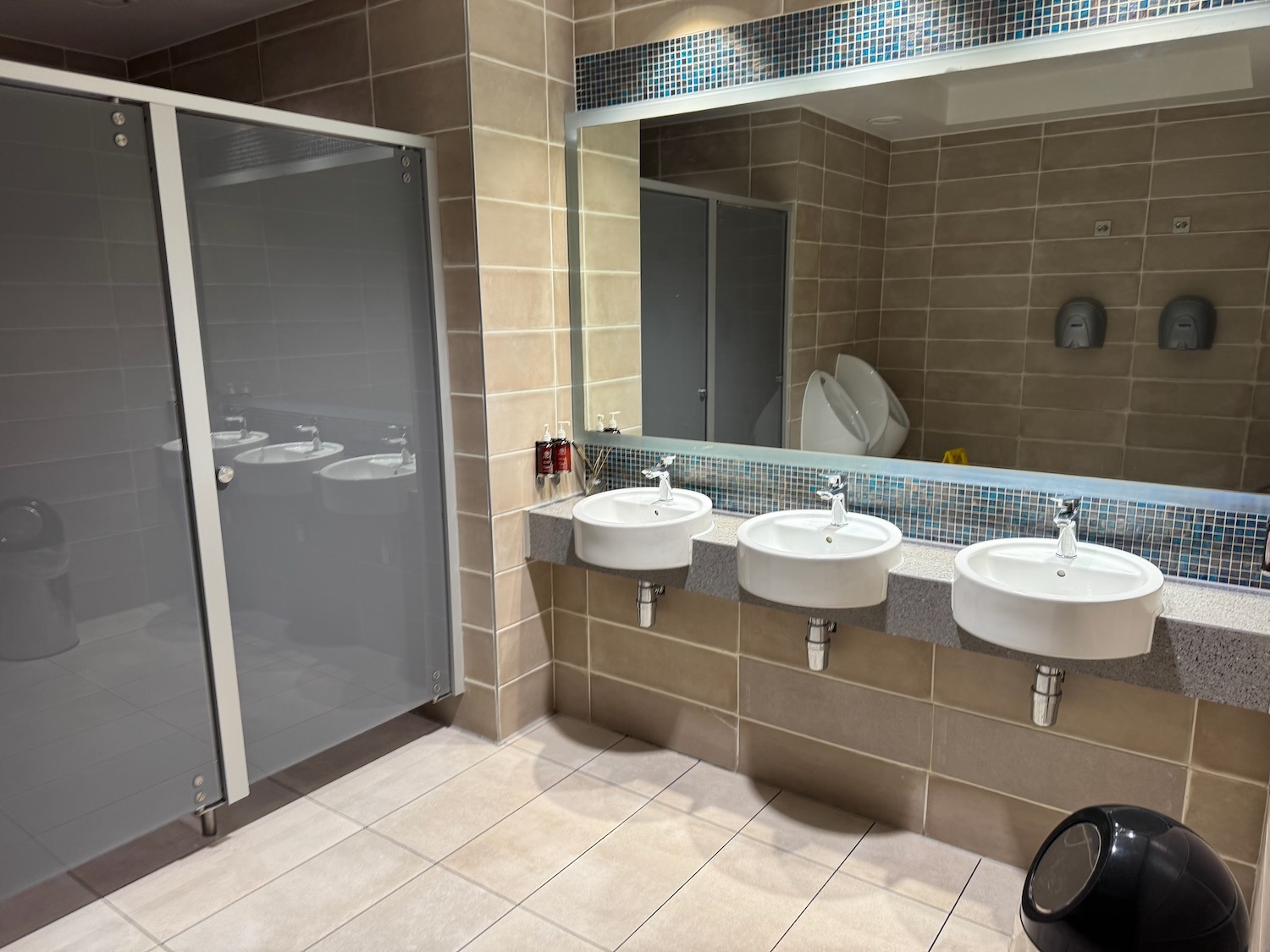 a bathroom with sinks and a shower