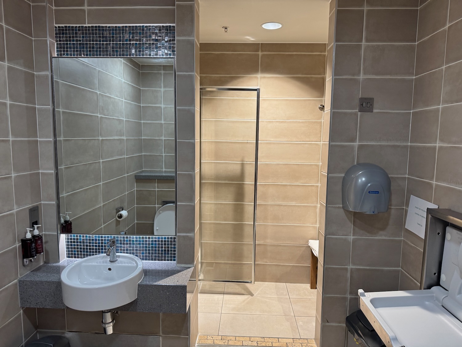 a bathroom with a shower and sink