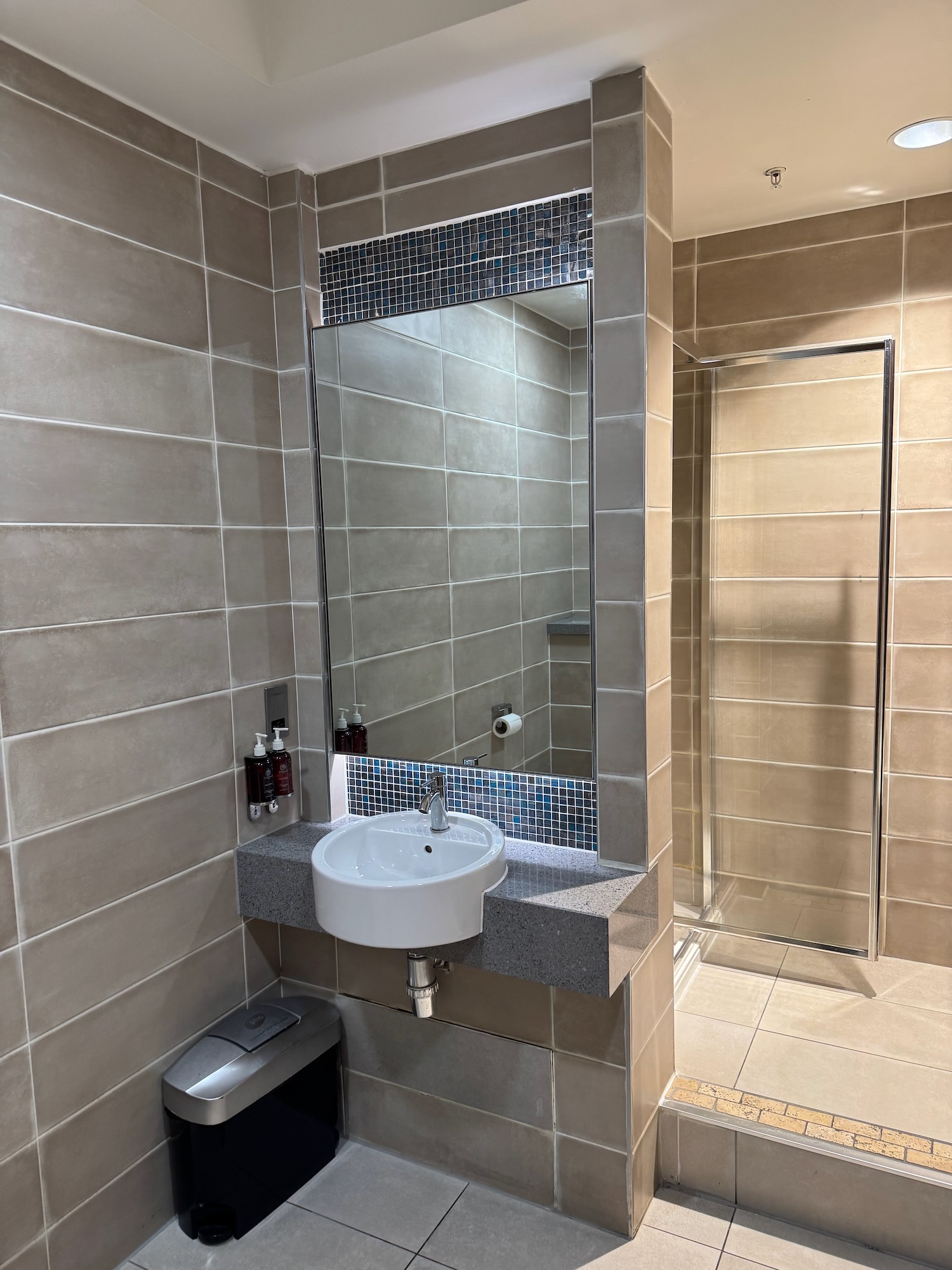 a bathroom with a mirror and sink