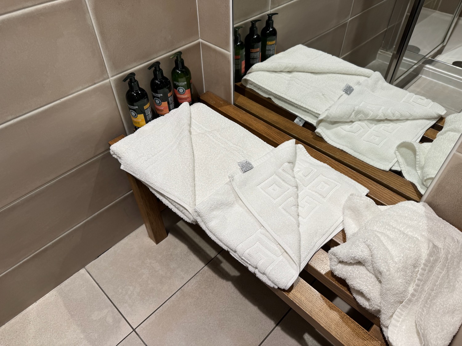 a group of white towels on a bench