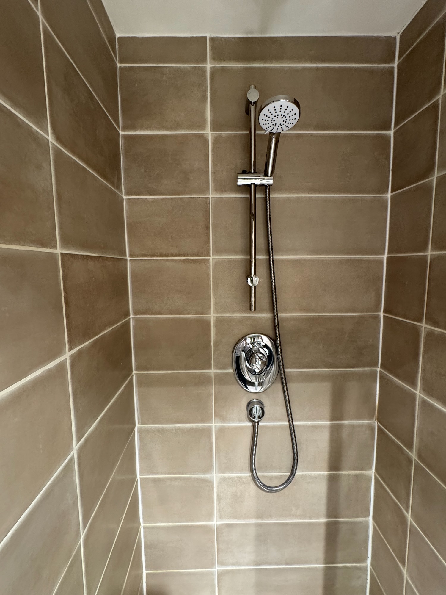a shower with a hose and a shower head