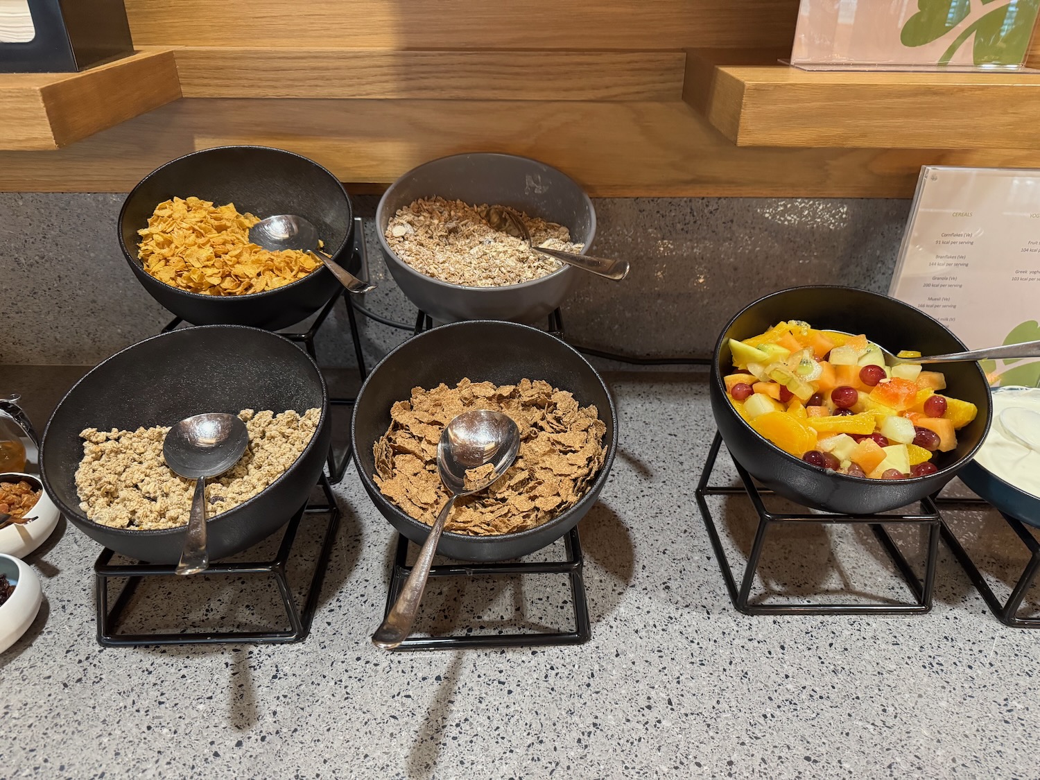 a group of bowls of cereal and fruit