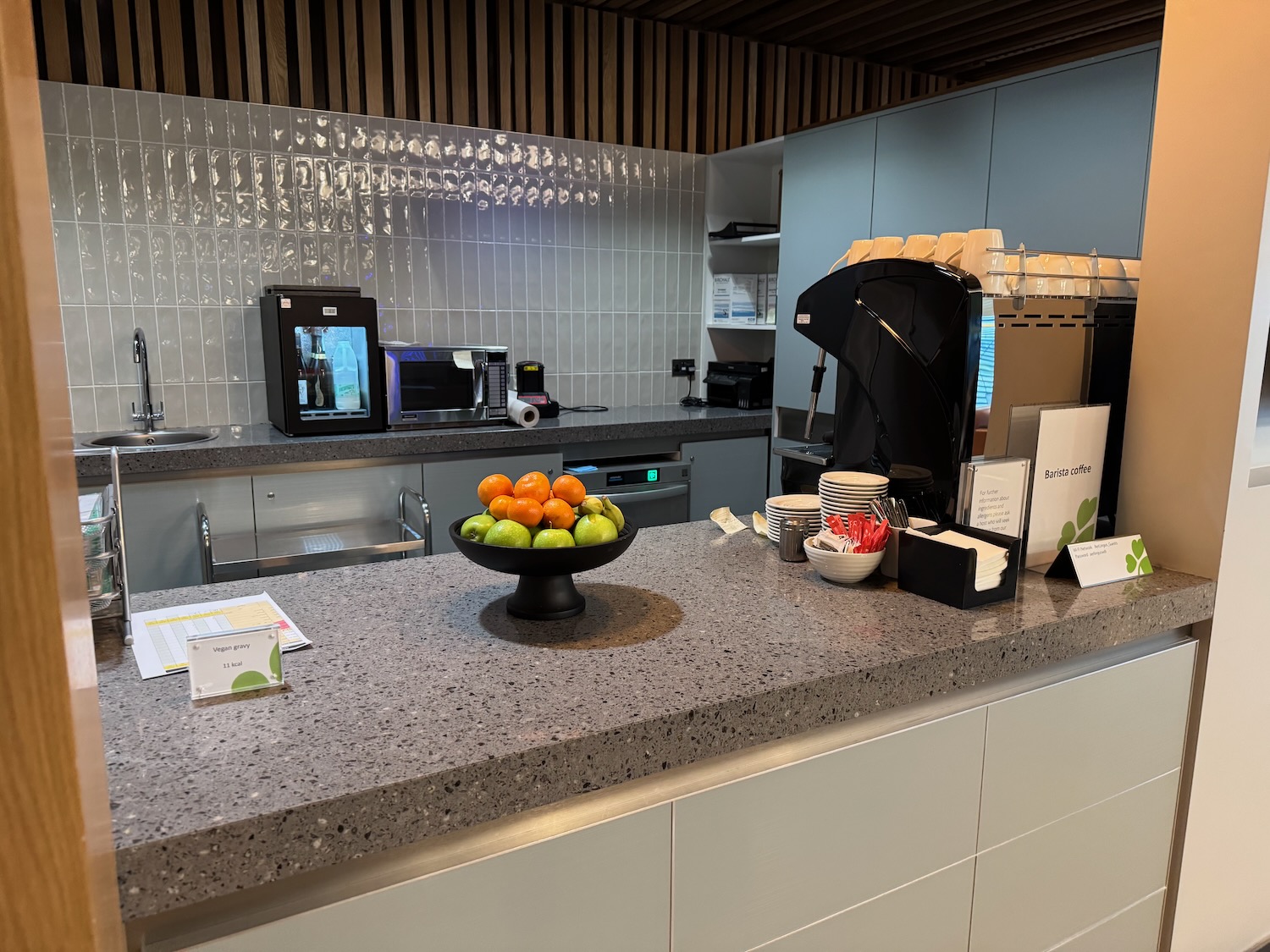 a counter with a bowl of fruit on it