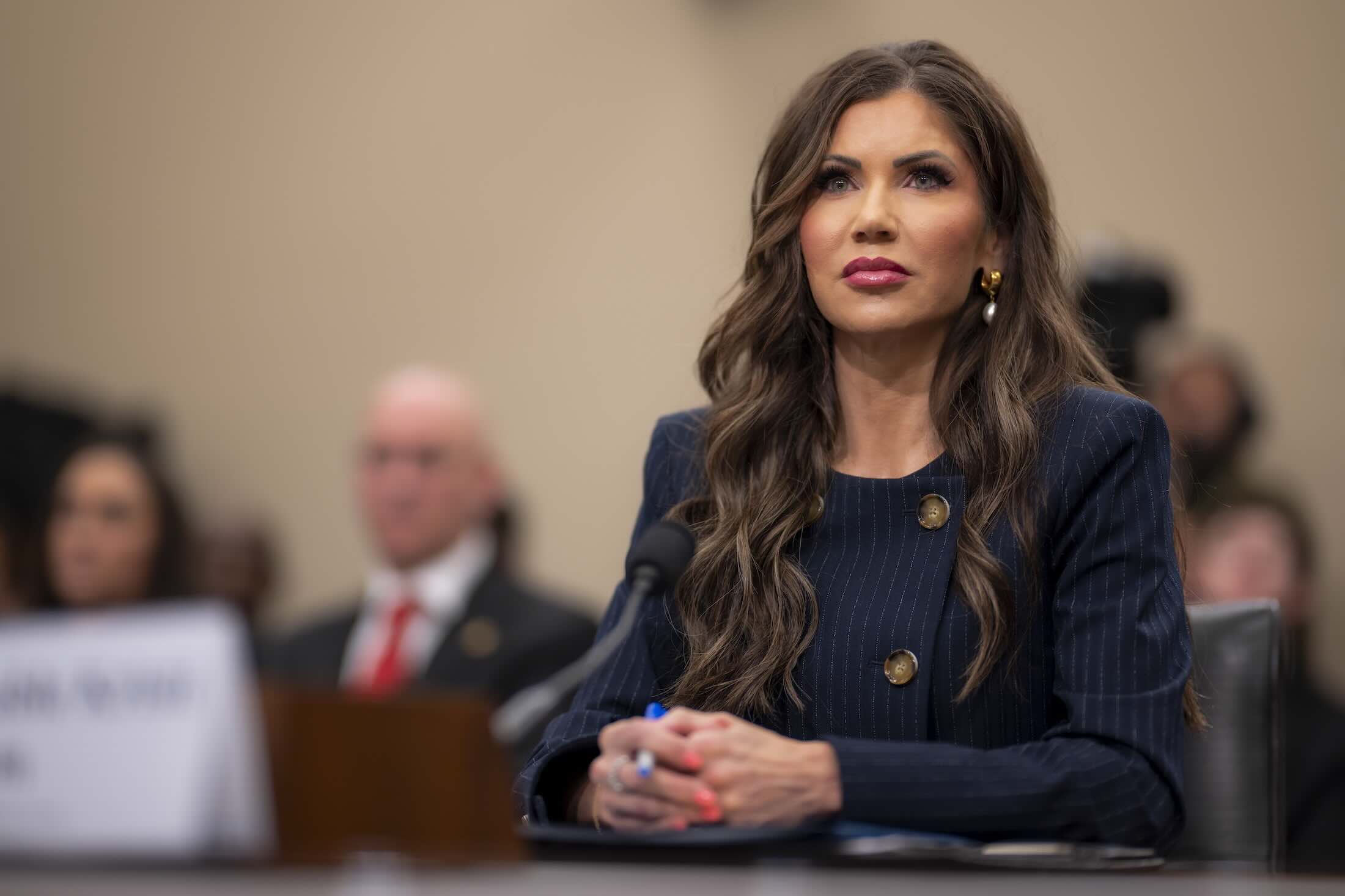 a woman sitting at a table with a microphone