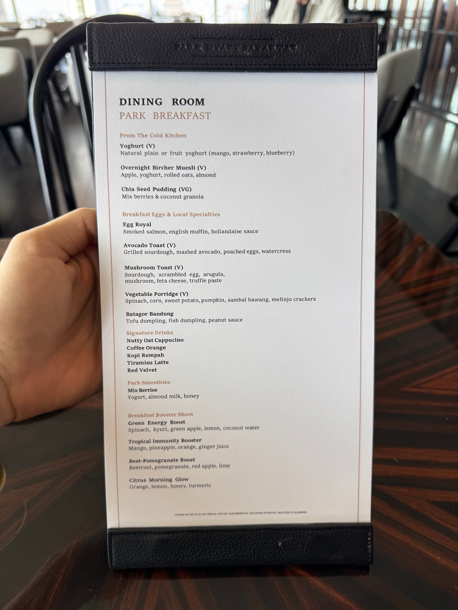 a hand holding a menu