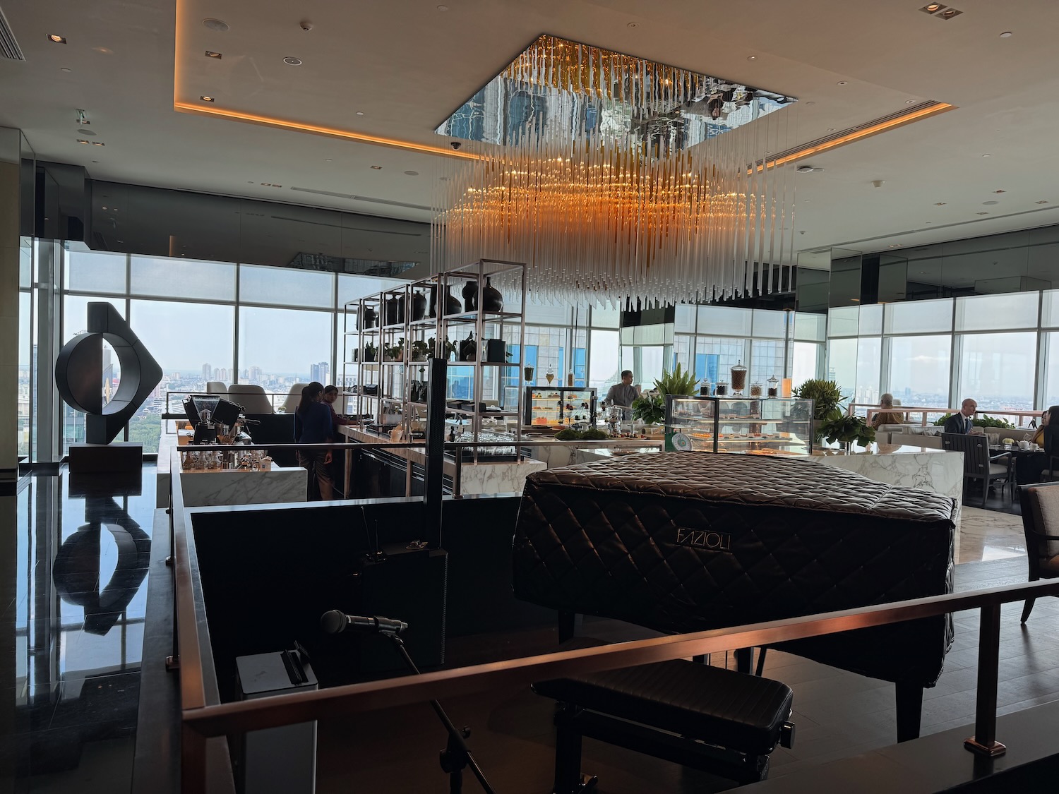 a room with a large chandelier and people in the background