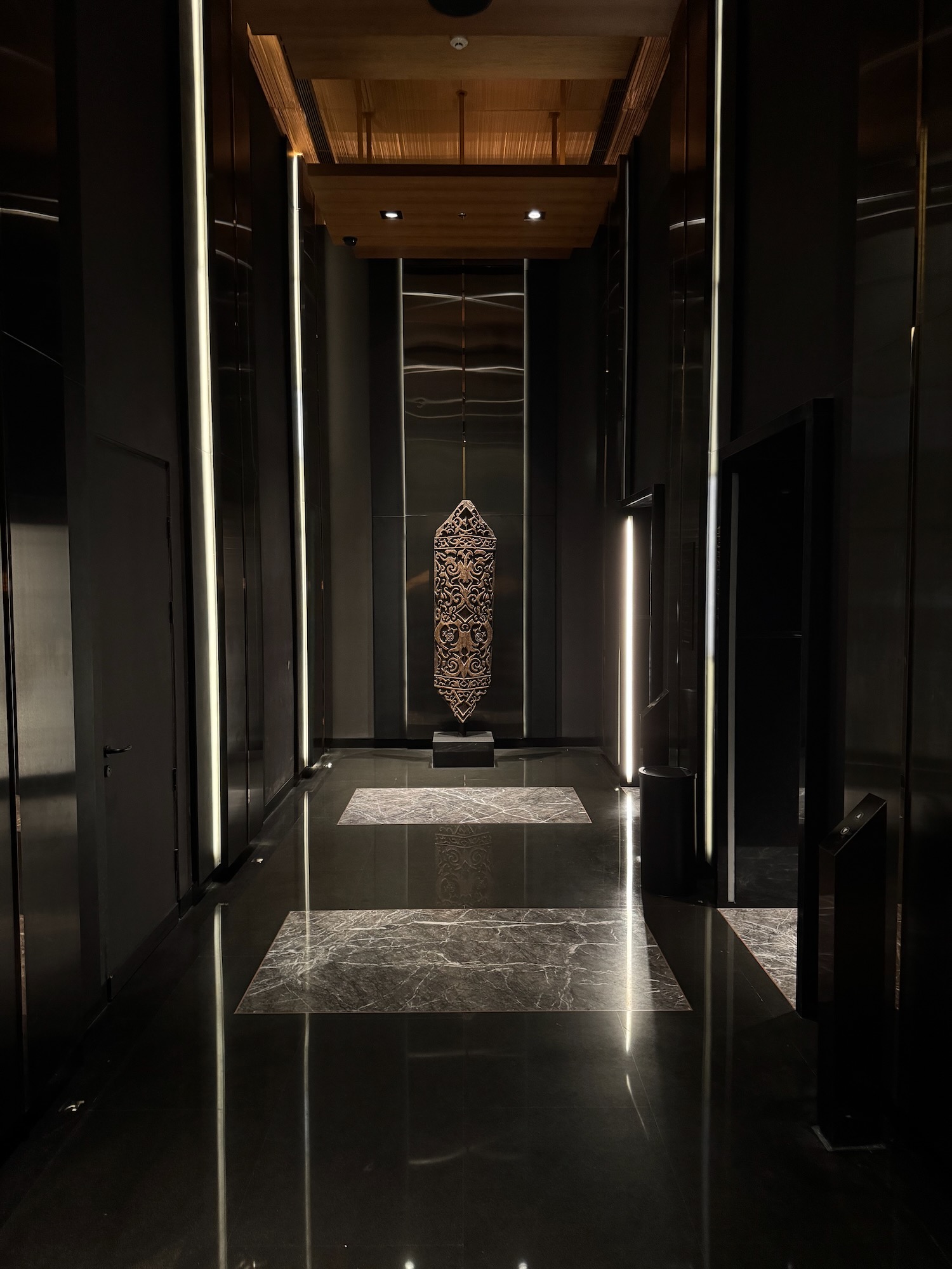 a black hallway with a large light