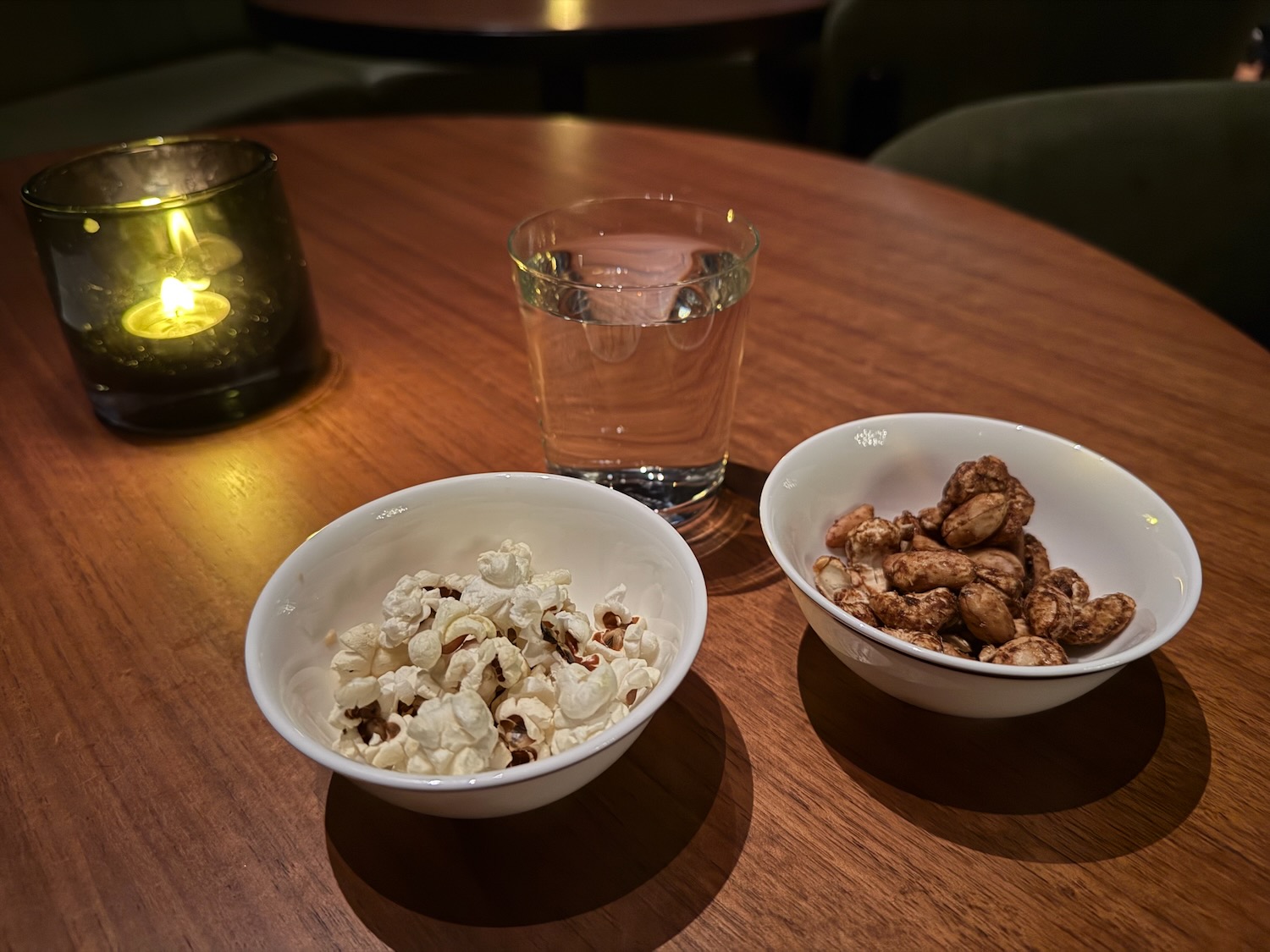 a bowl of popcorn and peanuts on a table