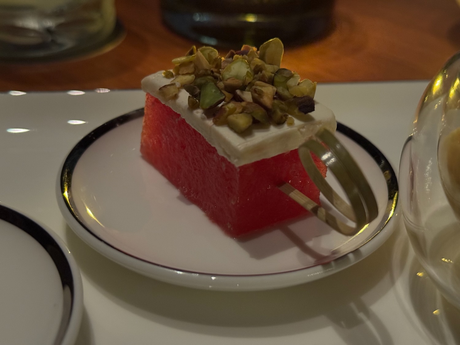 a piece of watermelon with a fork on a plate