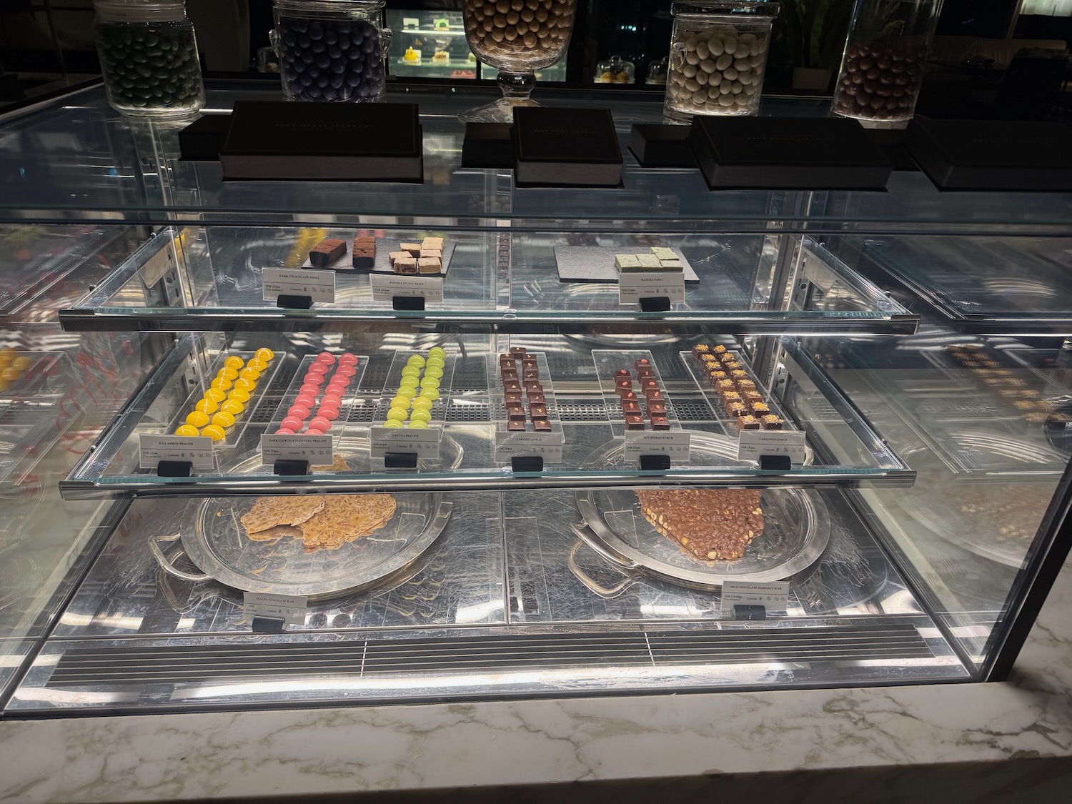 a display case with different colored candies