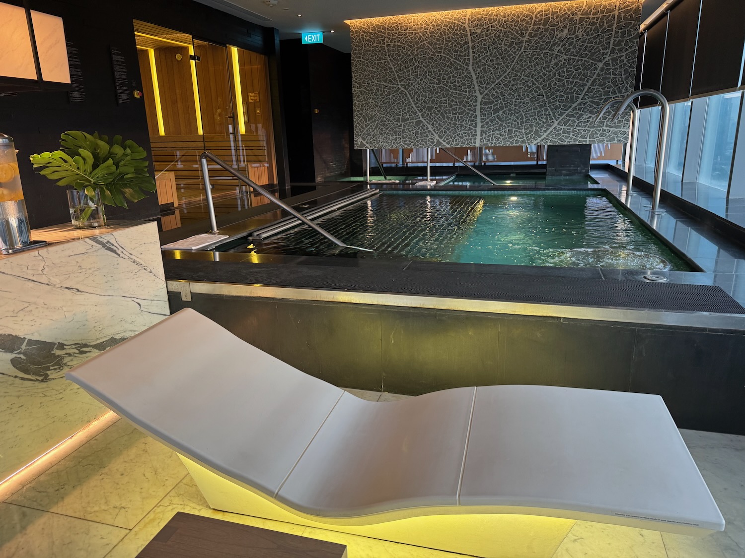 a pool with a lounge chair